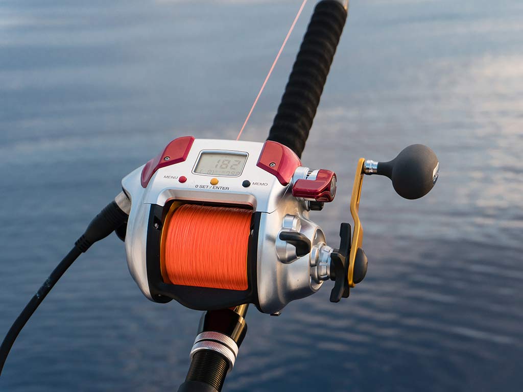 A closeup shot of an electric reel used for deep dropping.