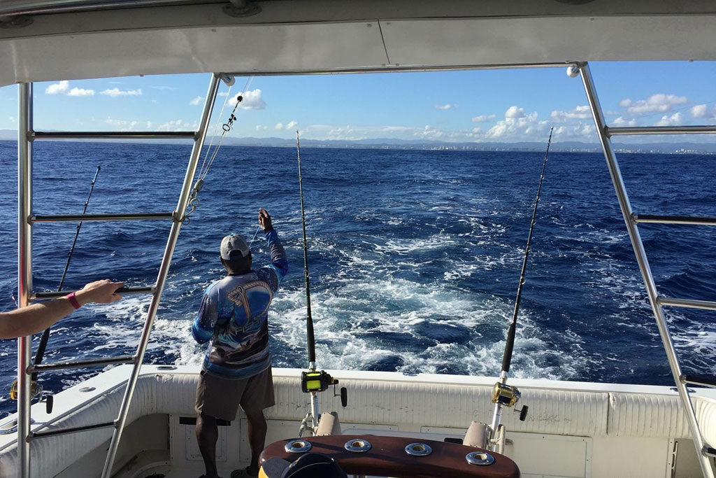 An angler looks out of the back of a boat trolling in Puerto Rico