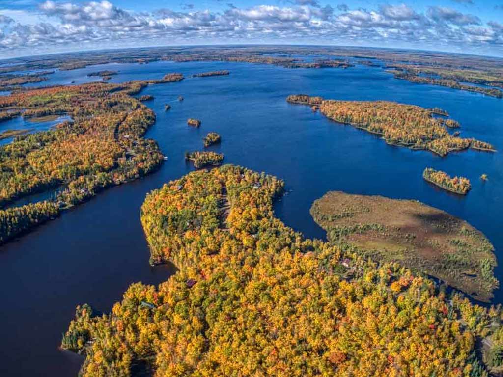 An aerial view of Lake Vermilion in Minnesota and the various islands in it, on a sunny fall day