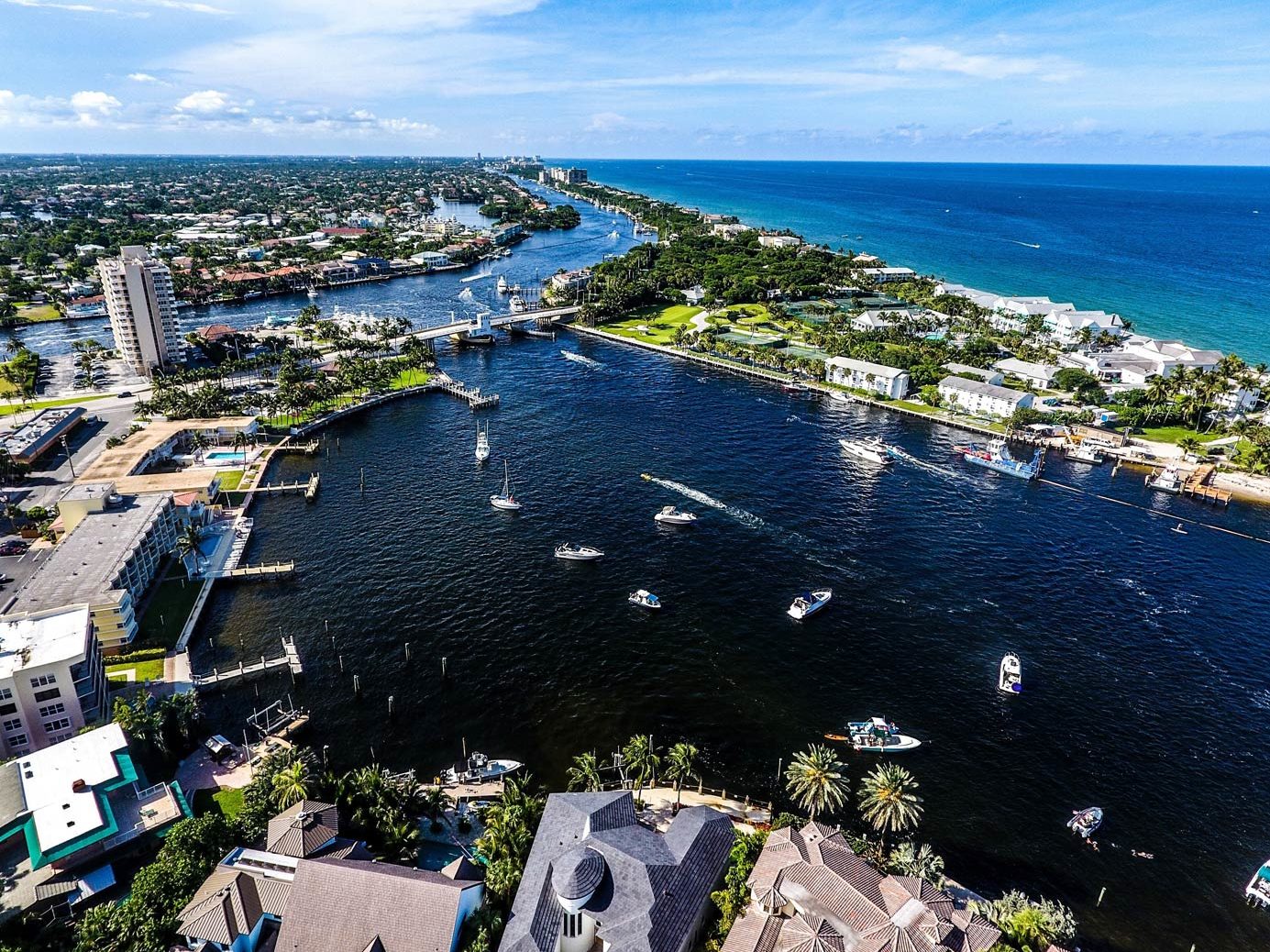 An aerial view of Pompano Beach with fishing boats leaving the bay