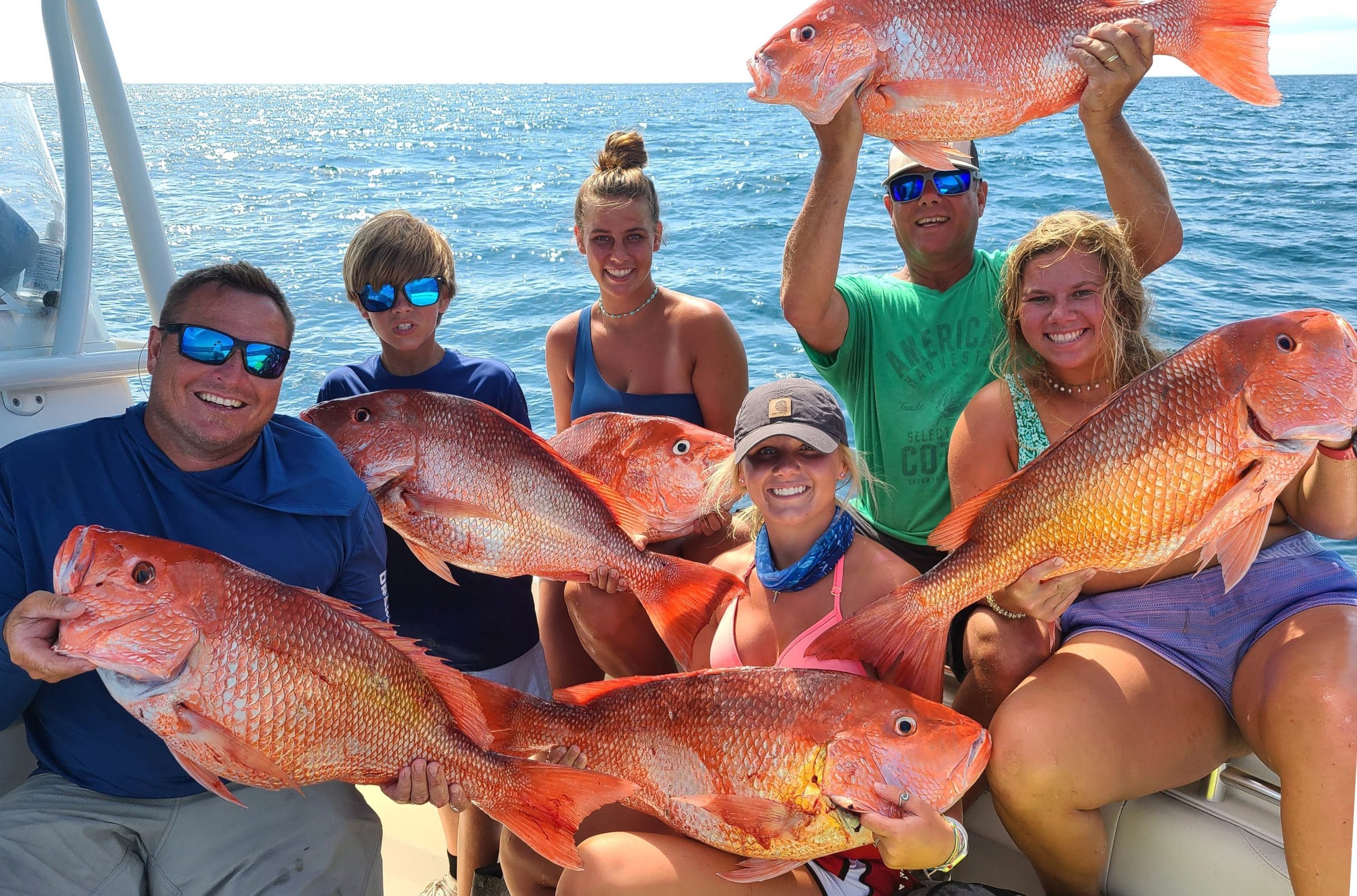 A group of anglers each holding Red Snapper caught with Rod Bender Fishing Charters LLC in St. Augustine, FL