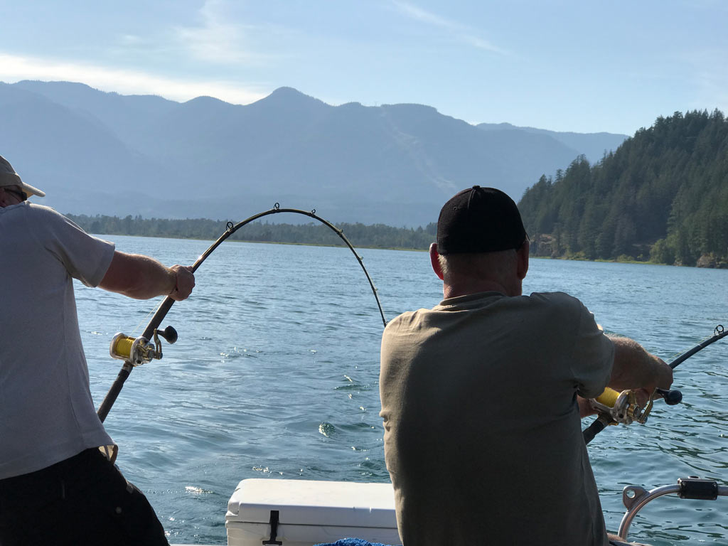 Two anglers fishing for Sturgeon using heavy tackle.