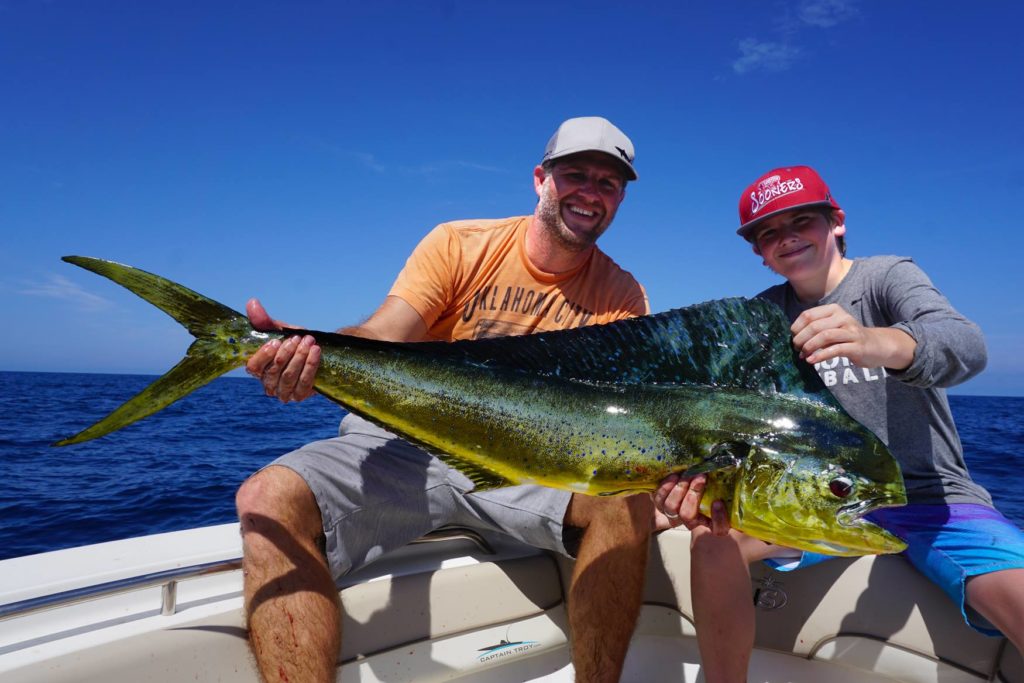 Two anglers holding Mahi Mahi caught with Captain Troy Inc in St. Augustine, Florida.