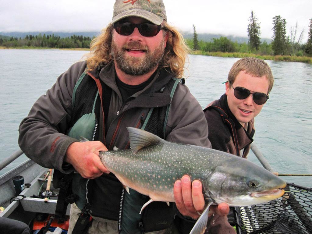 An angler holds a Dolly Varden he caught while fly fishing in Alaska.