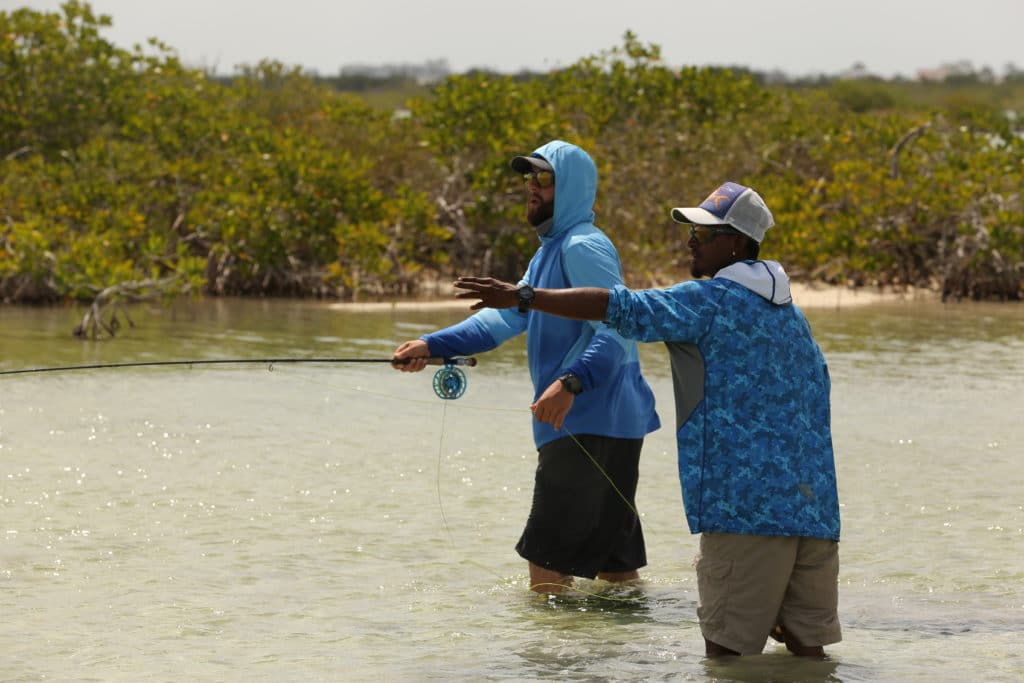 Two anglers fly fishing in Belize with V Land & Holding