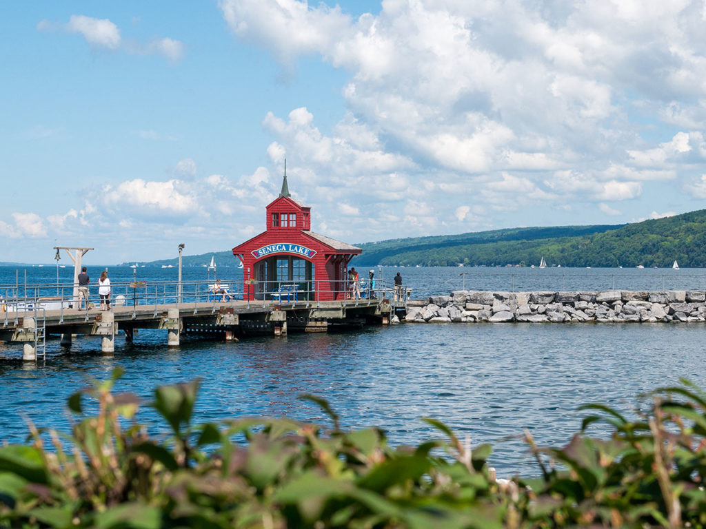 A fishing pier sticking out into Seneca Lake with the lake's name in big letters over the pavilion