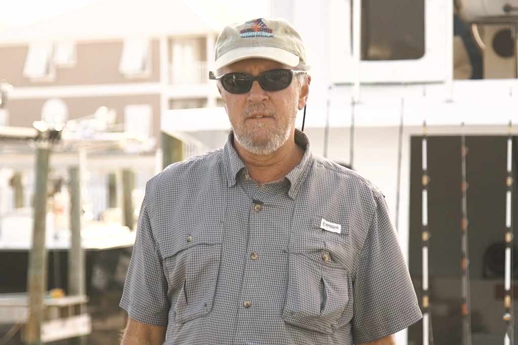 Captain Mike Salley standing in front of his boat in Orange Beach