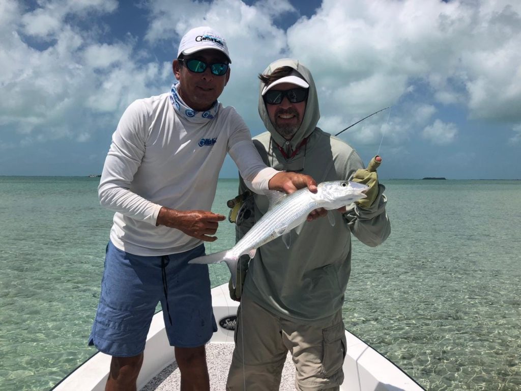 Two anglers with Bonefish caught while fishing with GoFish Belize