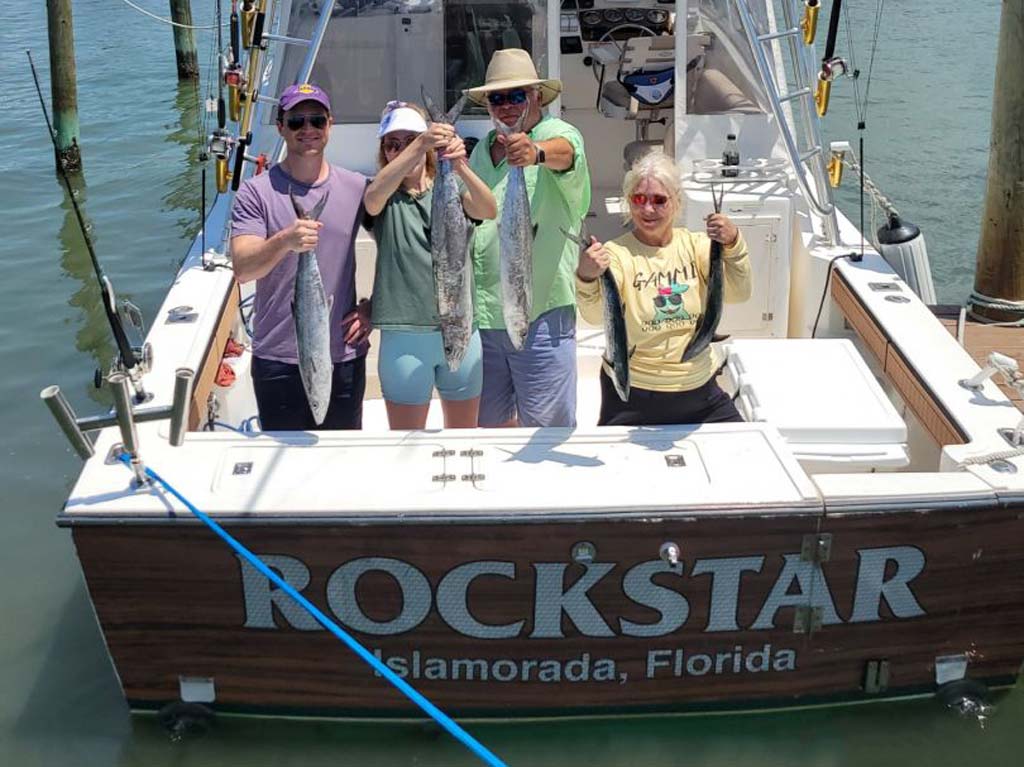 A group of anglers posing with fish they caught aboard Rockstar.