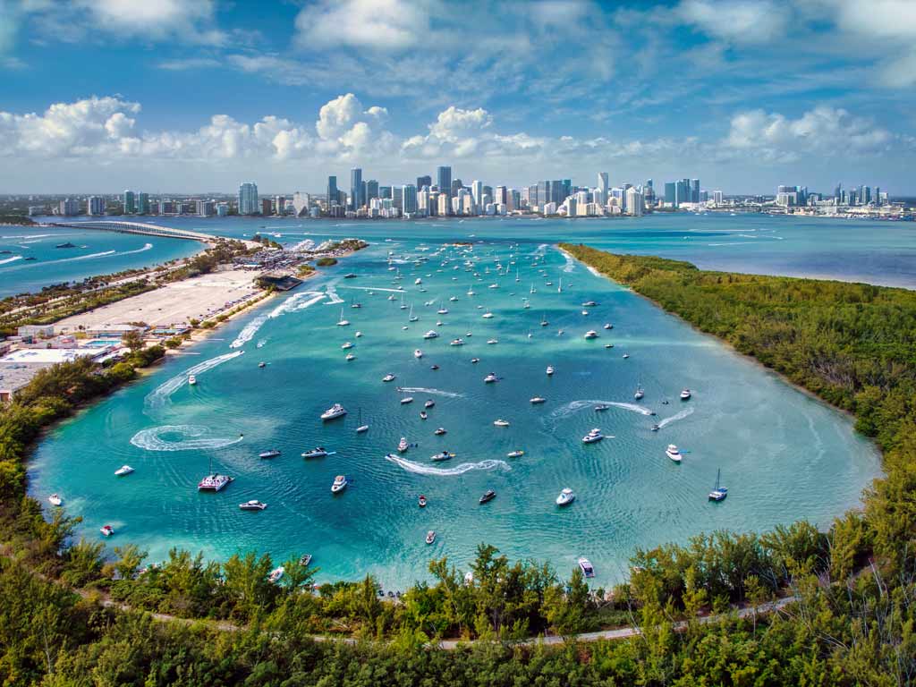 An aerial shot of Key Biscayne and Miami from Virginia Key with boats dotted along the bay.