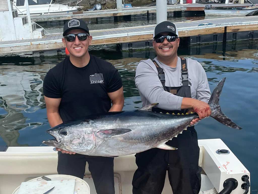 Two fishermen posing with a Bluefin Tuna caught offshore from Morro Bay.