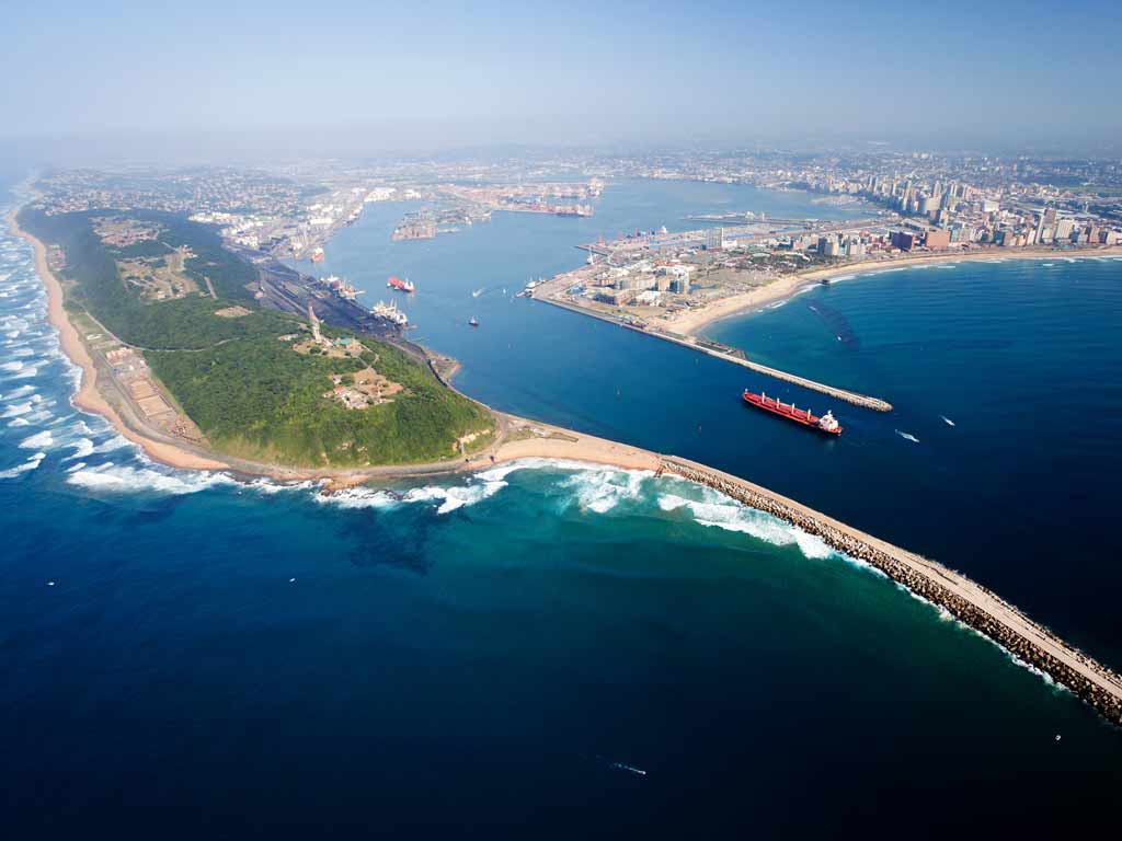 An aerial view of Durban Harbor with greenery on the left