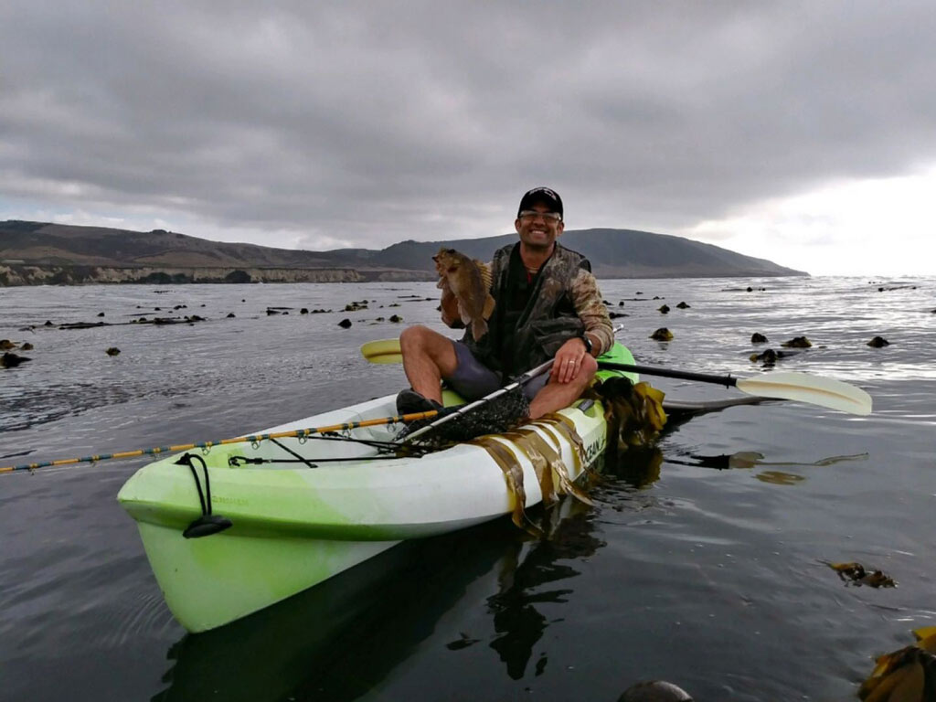 A kayak angler posing with a Lingcod caught south of Morro Bay.