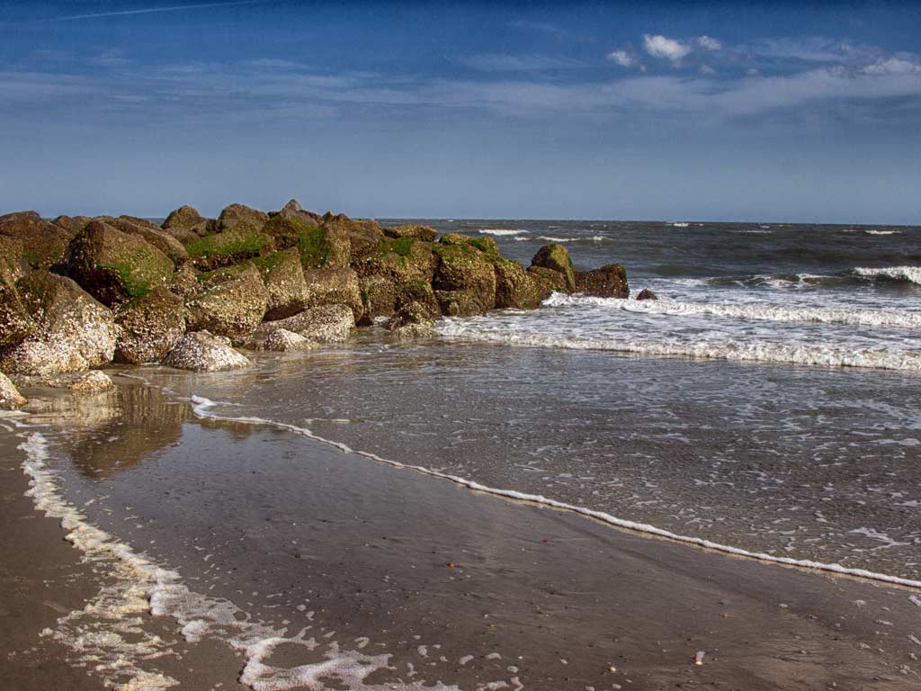 A photo of a jetty on Tybee Island with the Atlantic Ocean in the background.