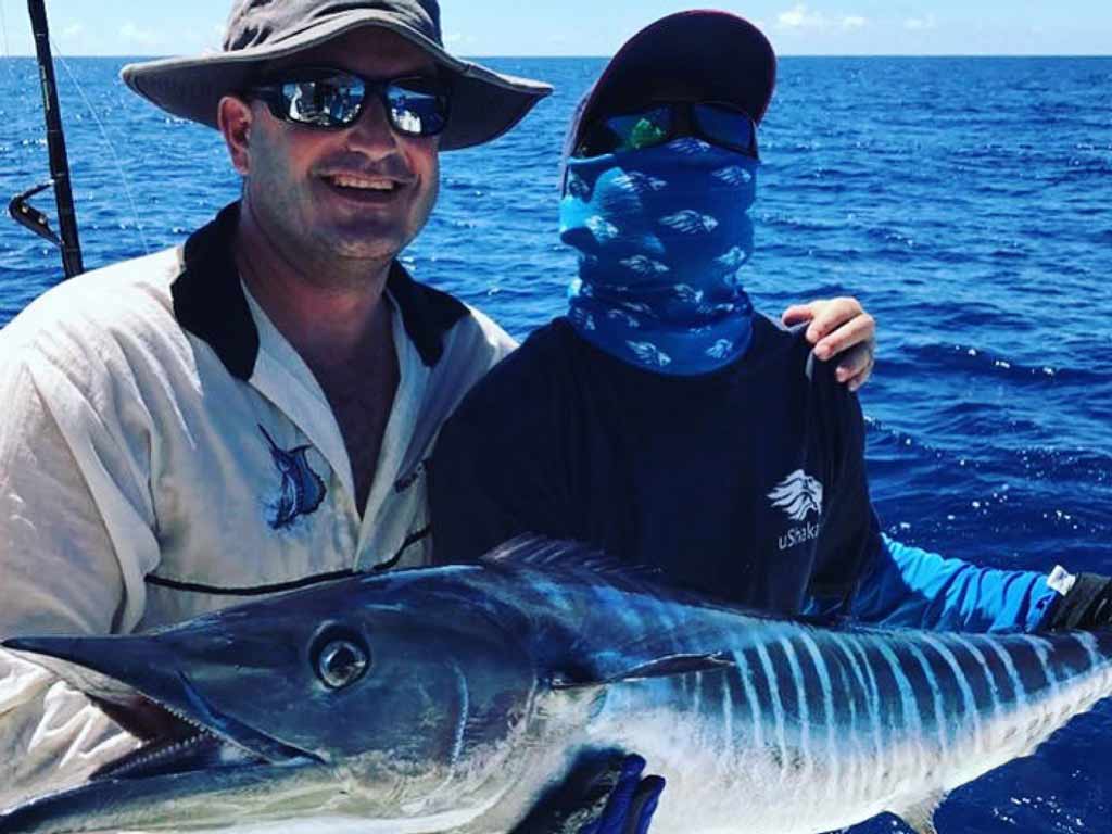 Two anglers holding big Wahoo