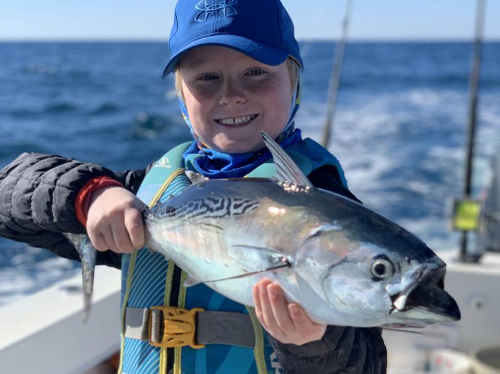 A happy kid with a False Albacore in his hands