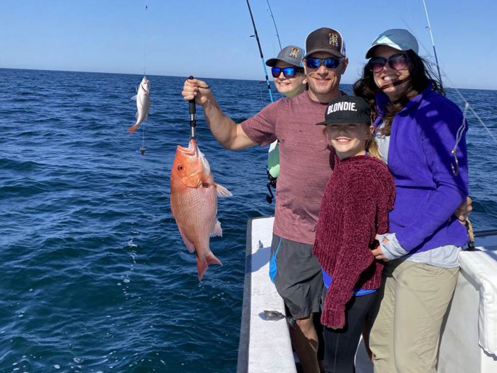 A family photo taken on Southern Country Charters boat while deep sea fishing in Destin, Florida