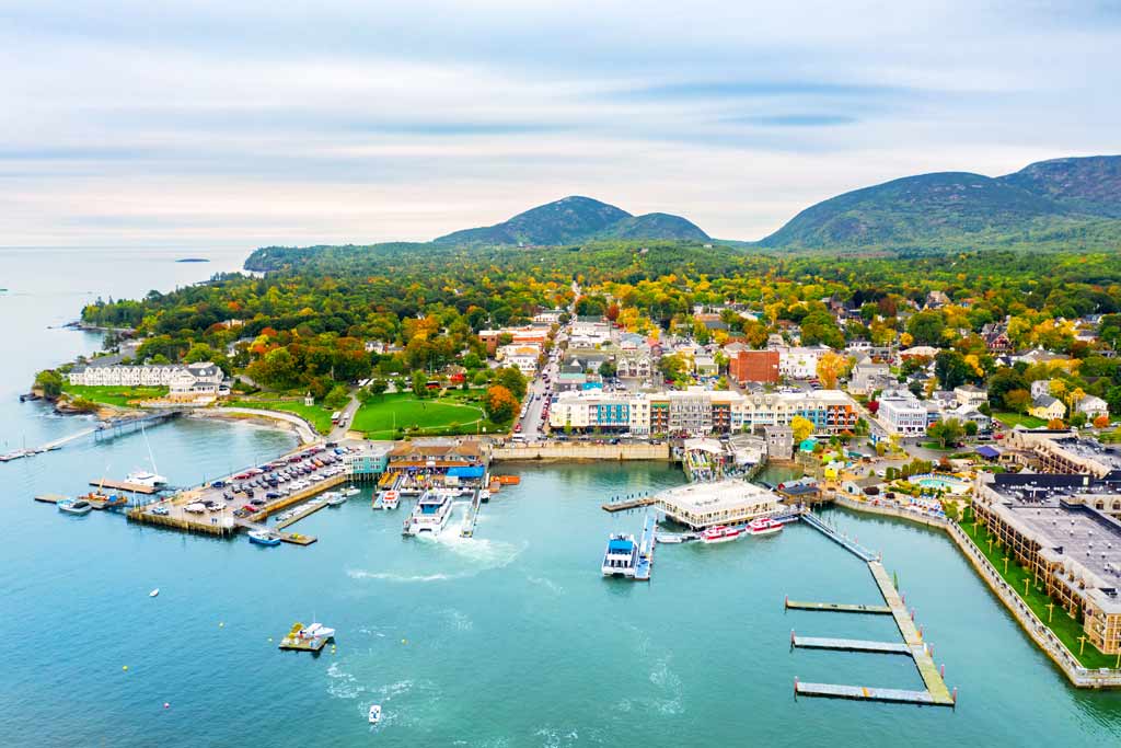 An aerial view of Bar Harbor, Maine with blue water, many docks, and houses