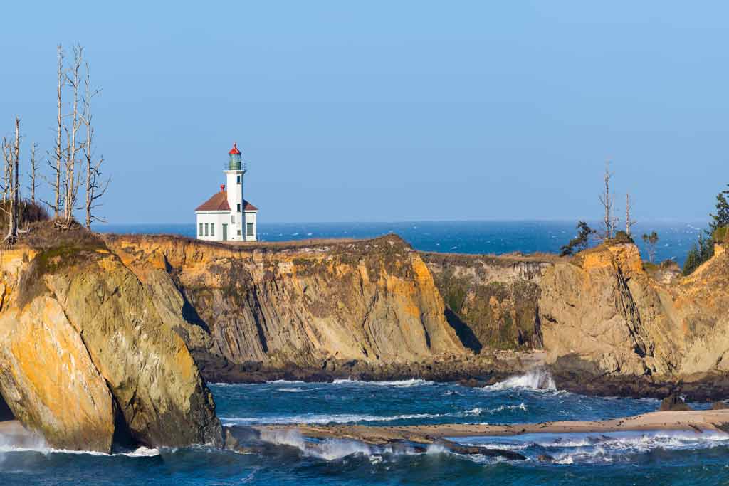 A view of Coos Bay from the water, with a church on the cliffs