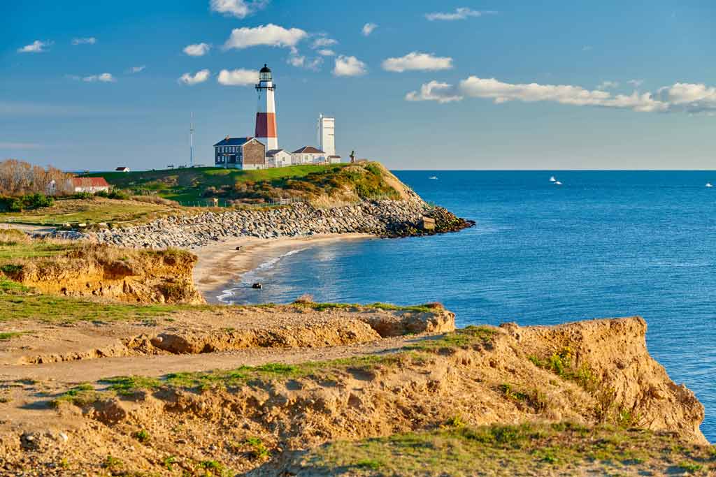 A view of the Montauk Lighthouse and surrounding cliffs and the Atlantic Ocean