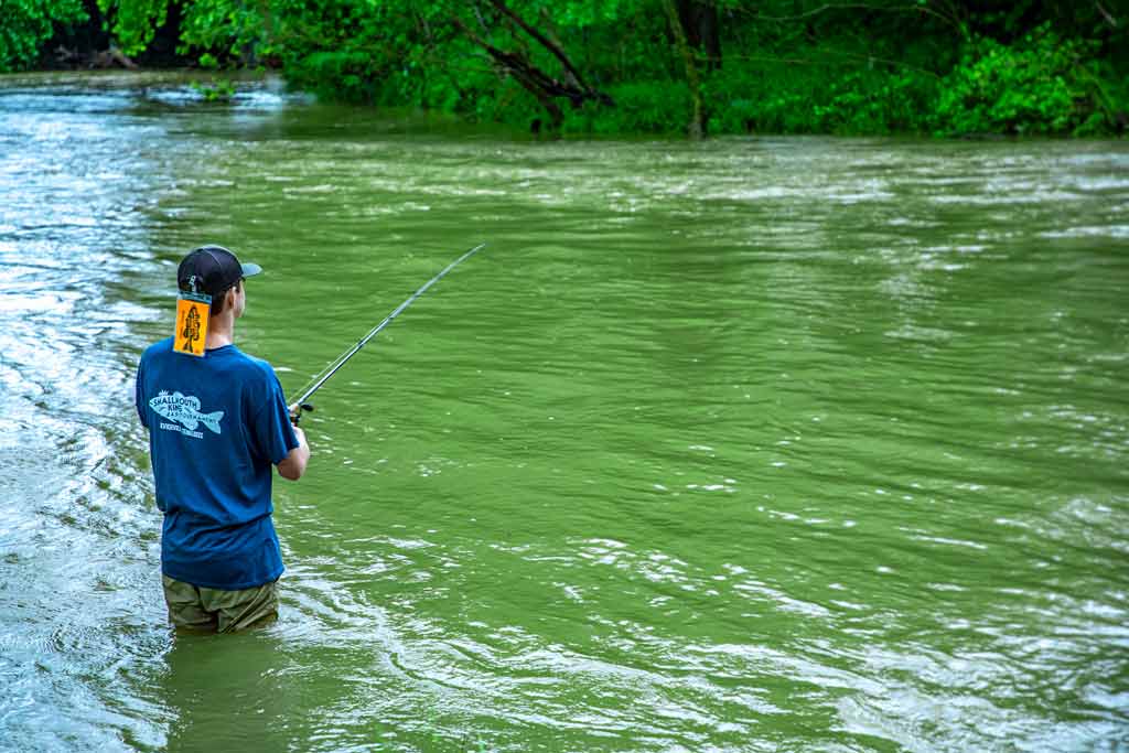 A young angler wading in a river near Sevierville, Tennessee