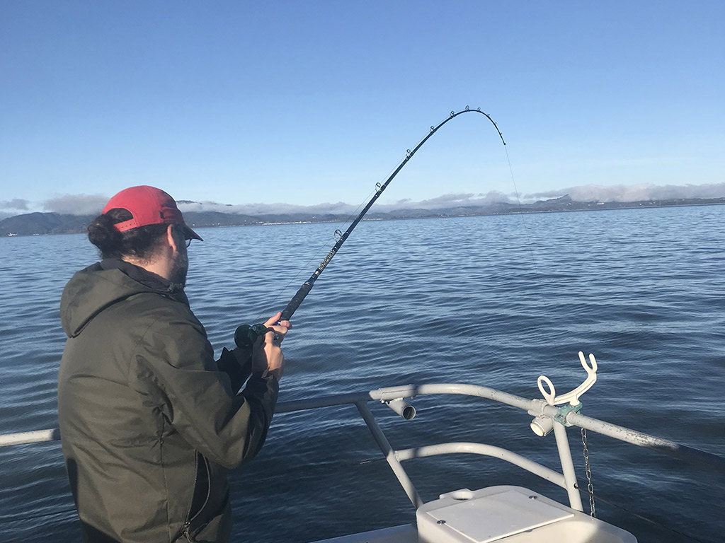 An angler bottom fishing somewhere in the Pacific near San Francisco.