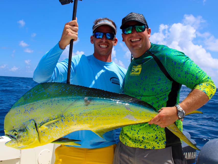 A picture of happy smiling anglers holding a freshly caught Mahi Mahi on a fishing boat powered by Yamaha engines, Cape Canaveral, Florida