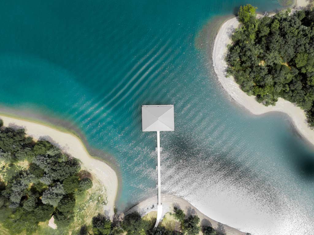 A bird's eye shot of Dale Hollow Lake and its famously clear waters, with a pier sicking out into the lake.