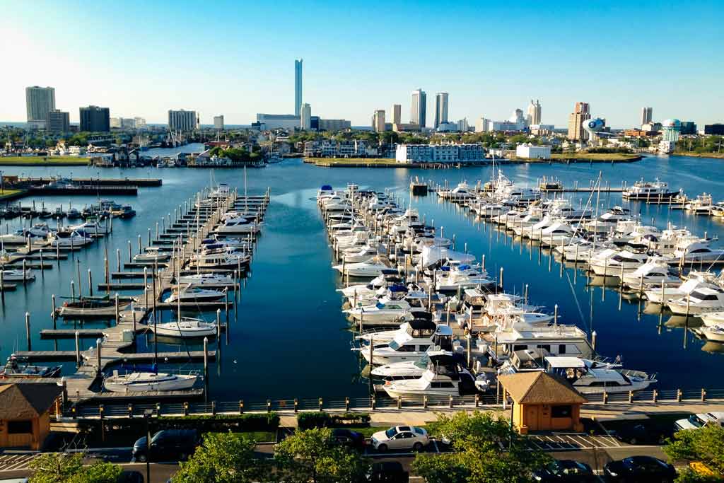 An aerial view of a boat marina in Atlantic City on a sunny day with the cityscaape in the background