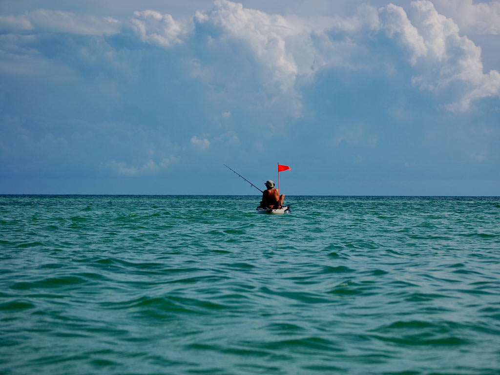 A photo of a person fishing in saltwater from a kayak.