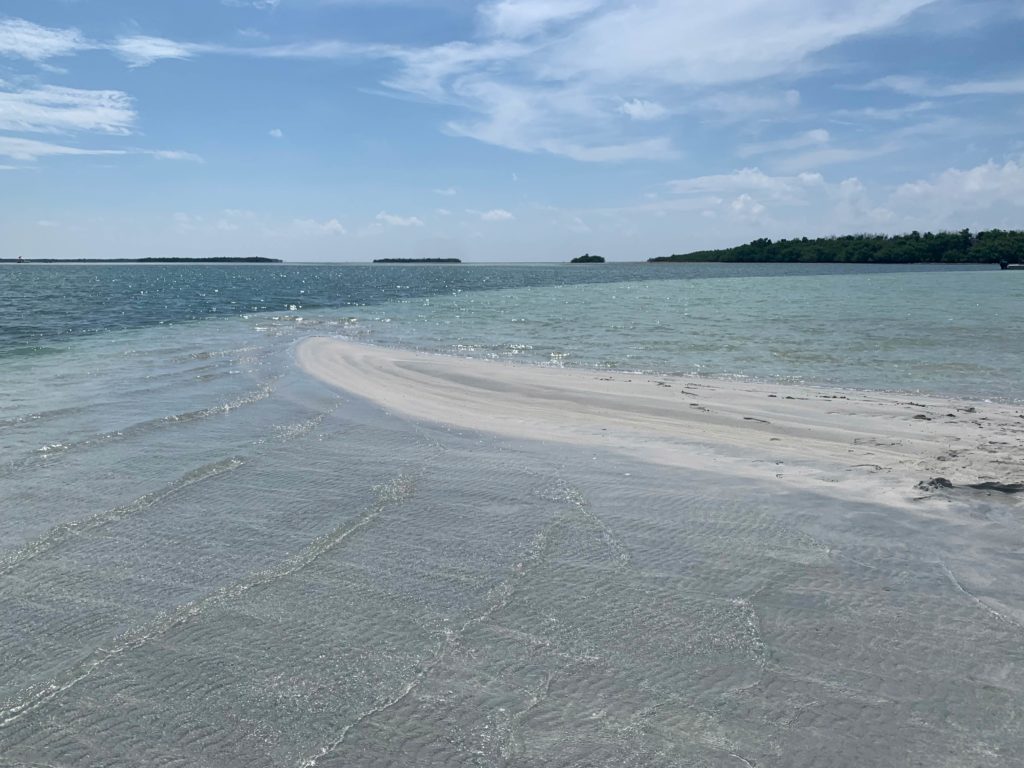 A picture showing the flats of Key West, Florida, on a sunny day, with the coast visible in the background 