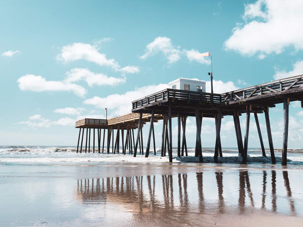 A fishing pier in Ocean City, as seen from the beach, with the Atlantic Ocean in the background.