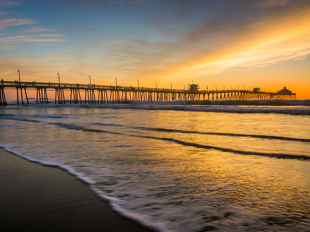 A view from the shore of a fishing pier in San Diego at sunset