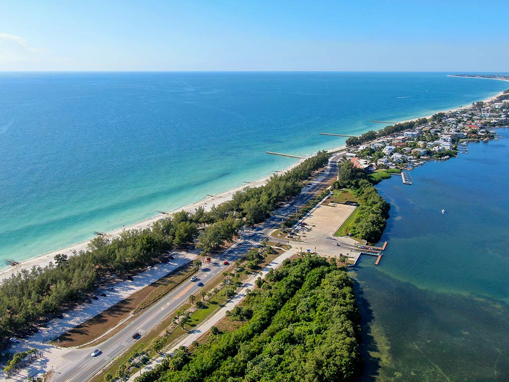 An aerial view looking from the bay to the Gulf of Mexico in Cortez, FL, on a sunny day