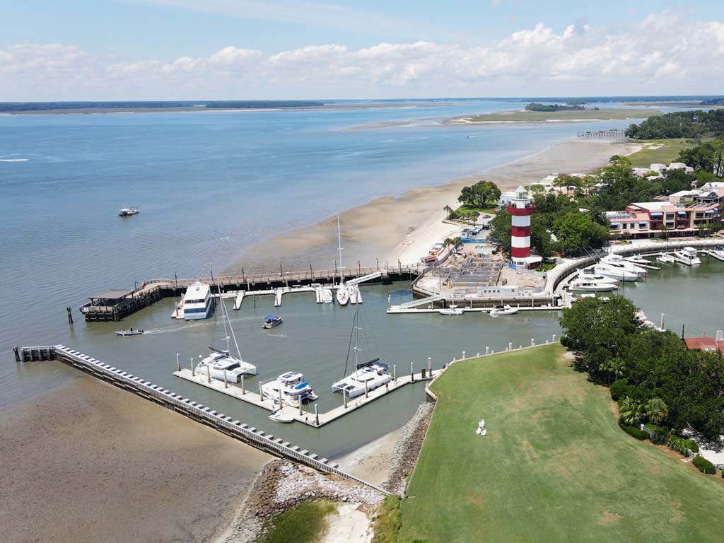 An aerial photo of the harbor, lighthouse, and the beach on Hilton Head Island.