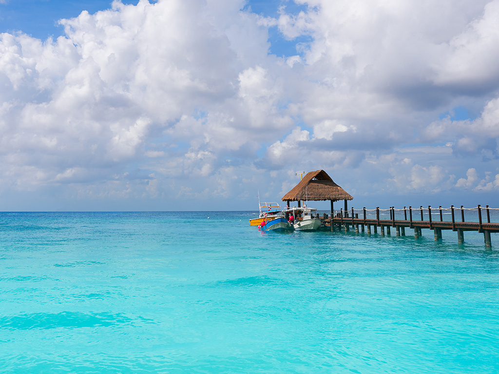 A view from the water of a quiet pier off the coast of Cozumel, Mexico.