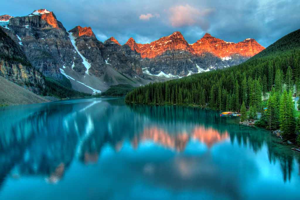 A view from a deep blue lake surrounded by high mountains in Canada