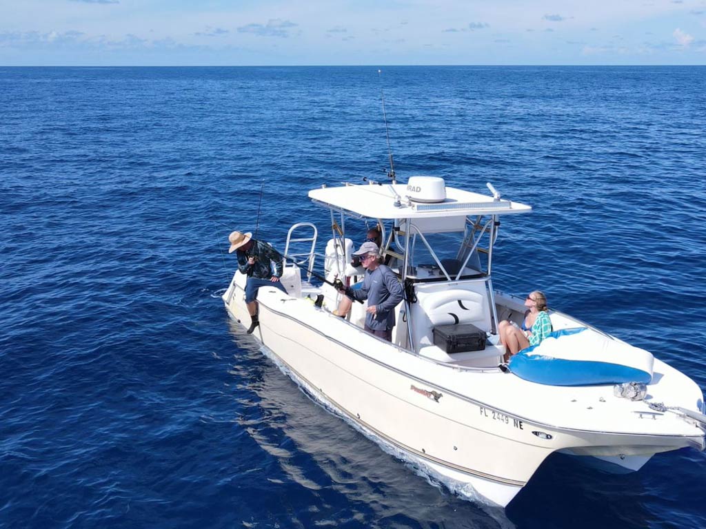 An aerial shot of a Tarpon Springs charter boat and its passengers and anglers anchored far offshore while deep sea fishing