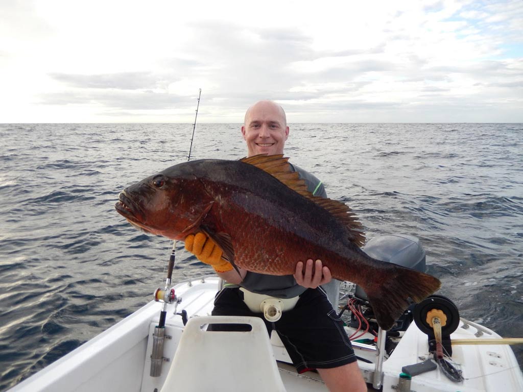 An angler holding a huge Cubera Snapper he caught fishing on the Pacific side of Costa Rica.