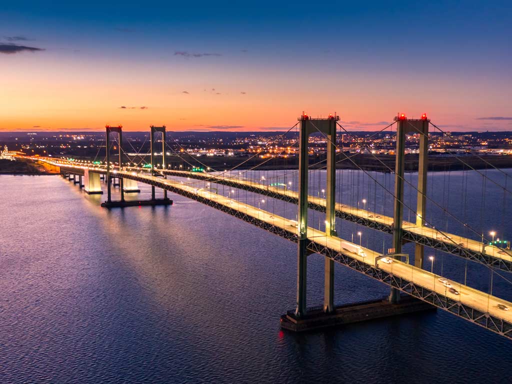 A sunset photo of the Delaware Memorial Bridge connecting Delaware and New Jersey.