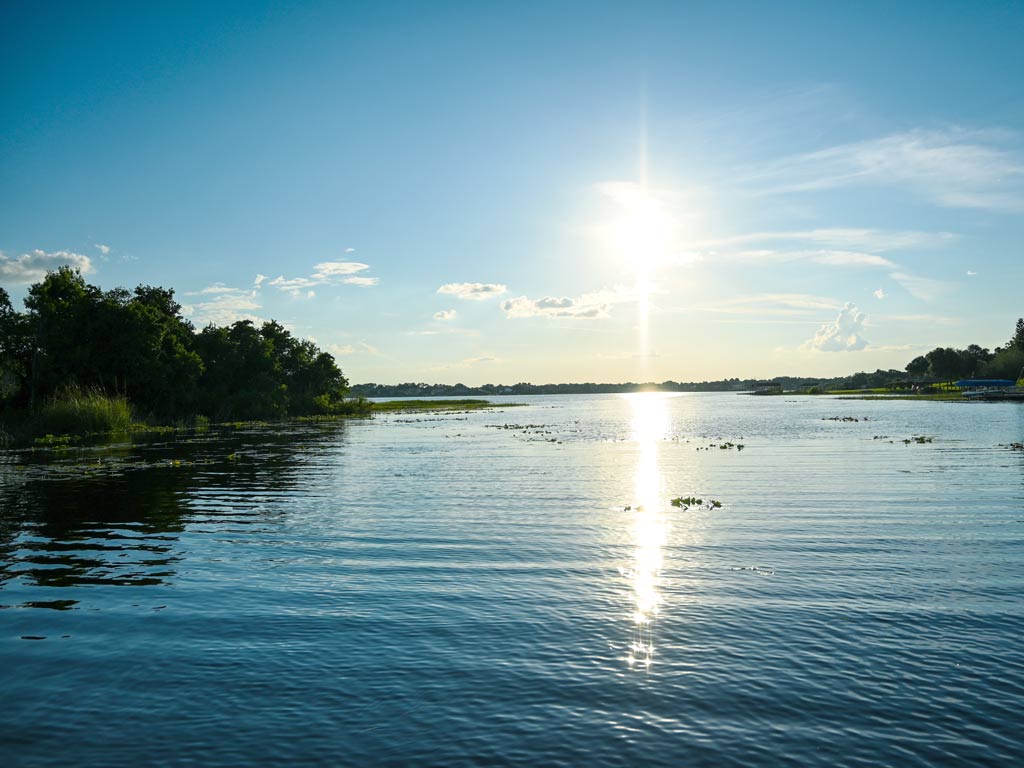 A scenic photo of Lake Butler and its surrounding greenery on a sunny day.