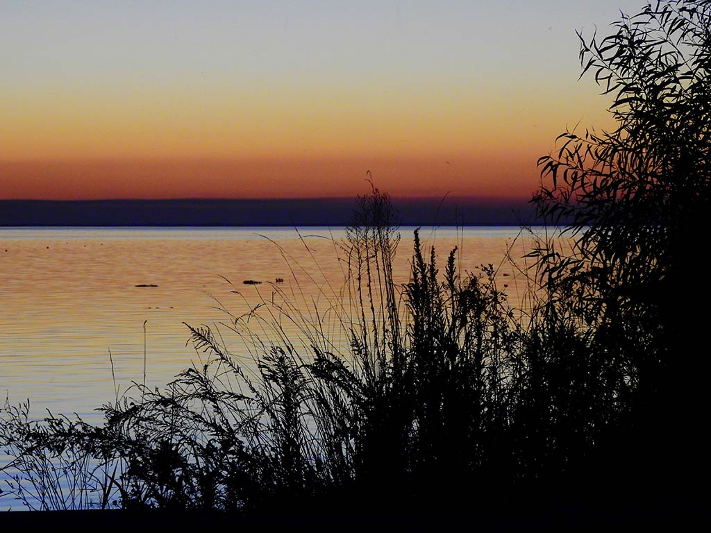 A view from the shore of Lake Maurepas after sunset