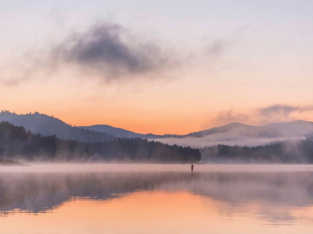 A beautiful sunset view of Lake Sheridan in the fog