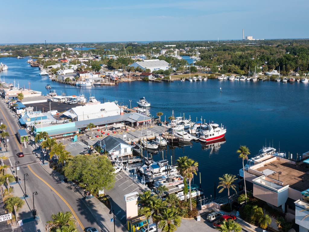 An aerial view of the water, roads, and boats docked in the marina in Tarpon Springs