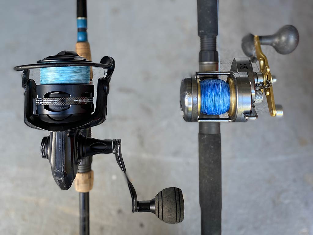 A closeup of two reels on fishing rods, with variegated reels and undecorous lines, suitable for fishing in Texas