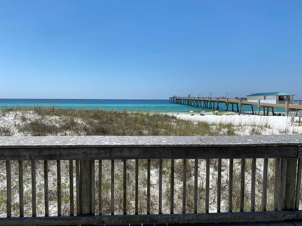 A view from the boardwalk of a fishing pier on Okaloosa Island on a sunny day