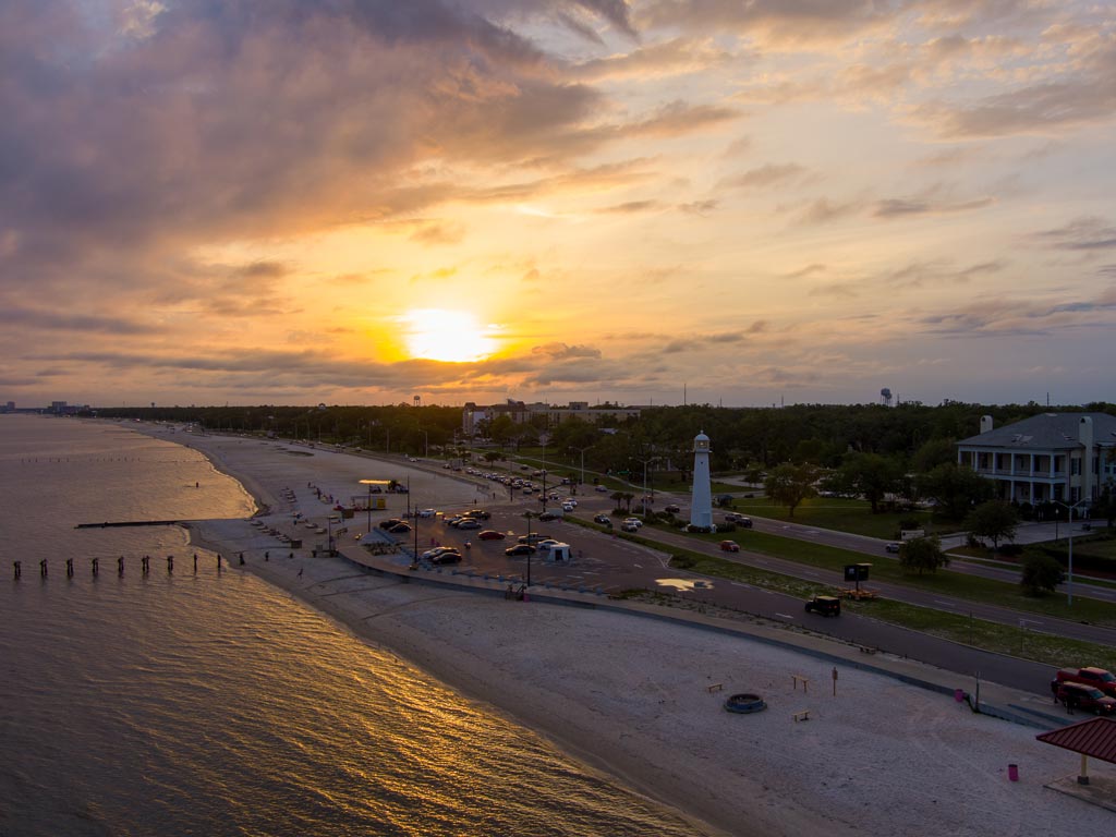 A sunset photo of a beach in Biloxi on Mississippi's Secret Coast, which serves as one of the best Presidents' Day fishing destinations in the US.