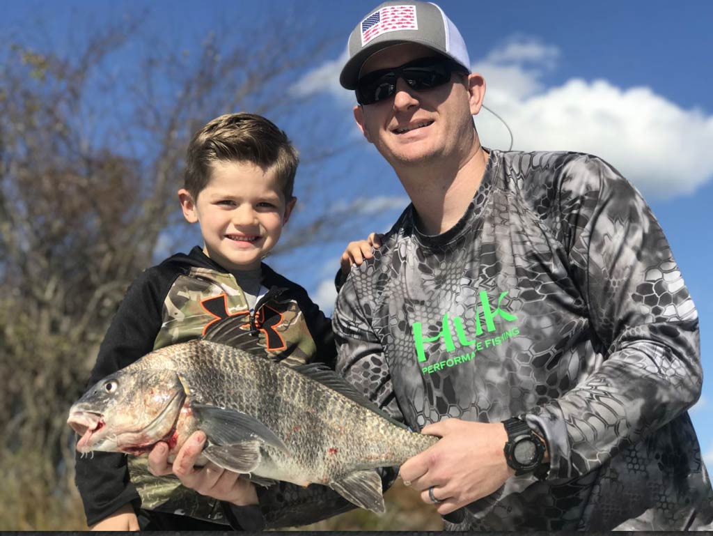 An angler with his child posing with Black Drum caught during the spring fishing season in South Carolina