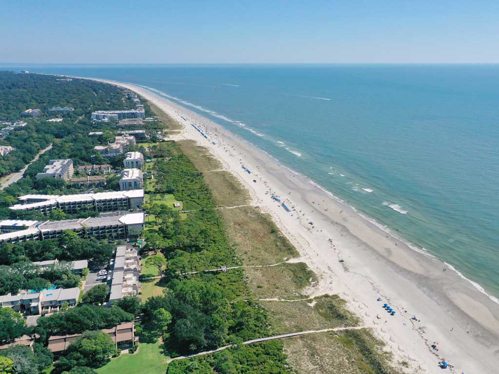 An aerial photo of Coligny Beach on Hilton Head Island on a clear day with the ocean on the right of the image.