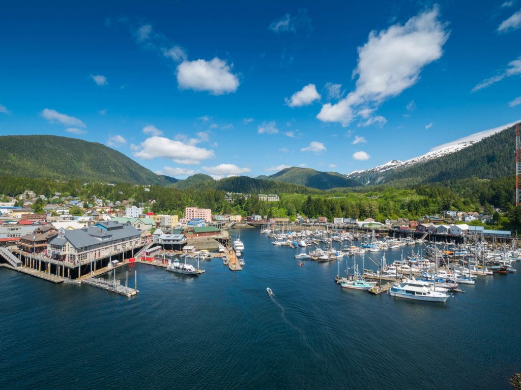 A view of a marina with boats docked on a sunny day in Ketchikan, Alaska